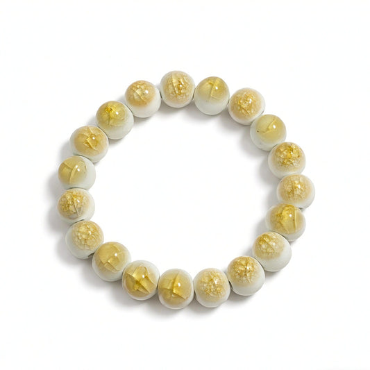 LUMI yellow crackle ceramic bracelet laid flat — a handmade Jingdezhen porcelain gift for her