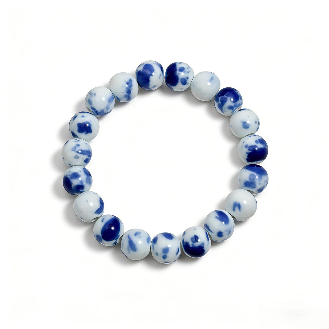 Handmade Jingdezhen porcelain beads on a LUMI Qing Hua ceramic bracelet — each bead shaped, glazed and kiln-fired by hand