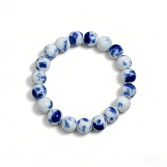 Handmade Jingdezhen porcelain beads on a LUMI Qing Hua ceramic bracelet — each bead shaped, glazed and kiln-fired by hand