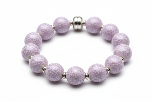 a beaded porcelain bracelets with ice crackled glaze in lavender mist on top of each bead on a white background