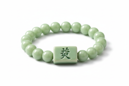 a light green beaded porcelain bracelet with an embossed green "發" mahjong tile in the middle of the product on a white background