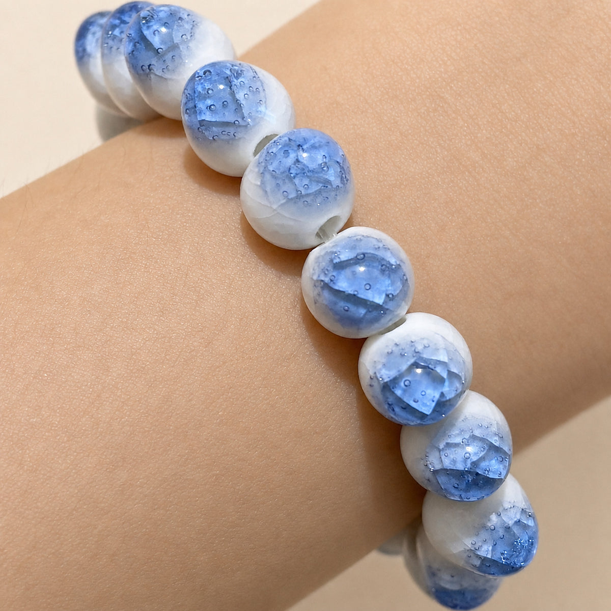 LUMI blue ice-crackle glaze ceramic bracelet 10mm — close-up of glaze texture and hand-finished beads