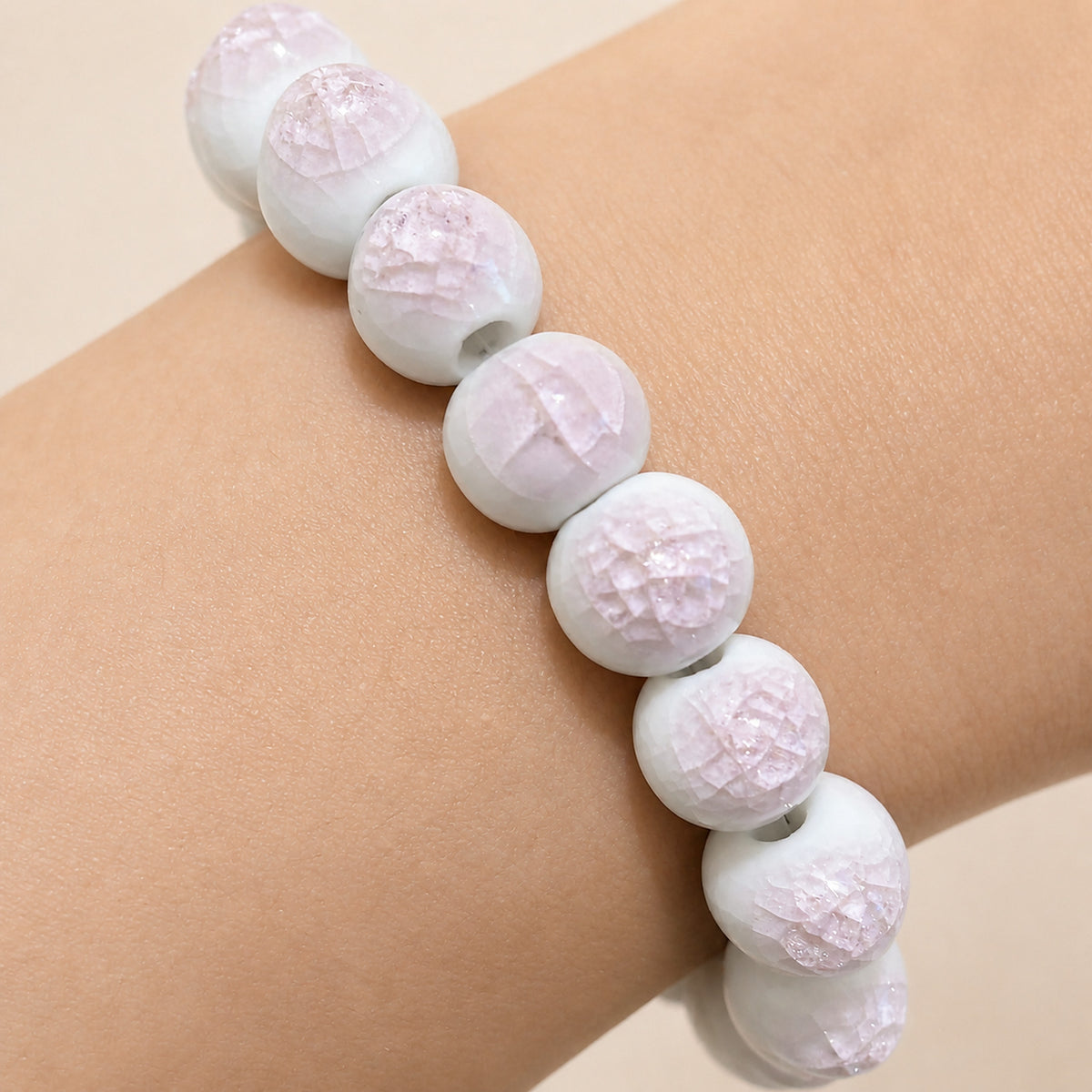 LUMI pink ice-crackle glaze ceramic bracelet 10mm — close-up of glaze texture and hand-finished beads