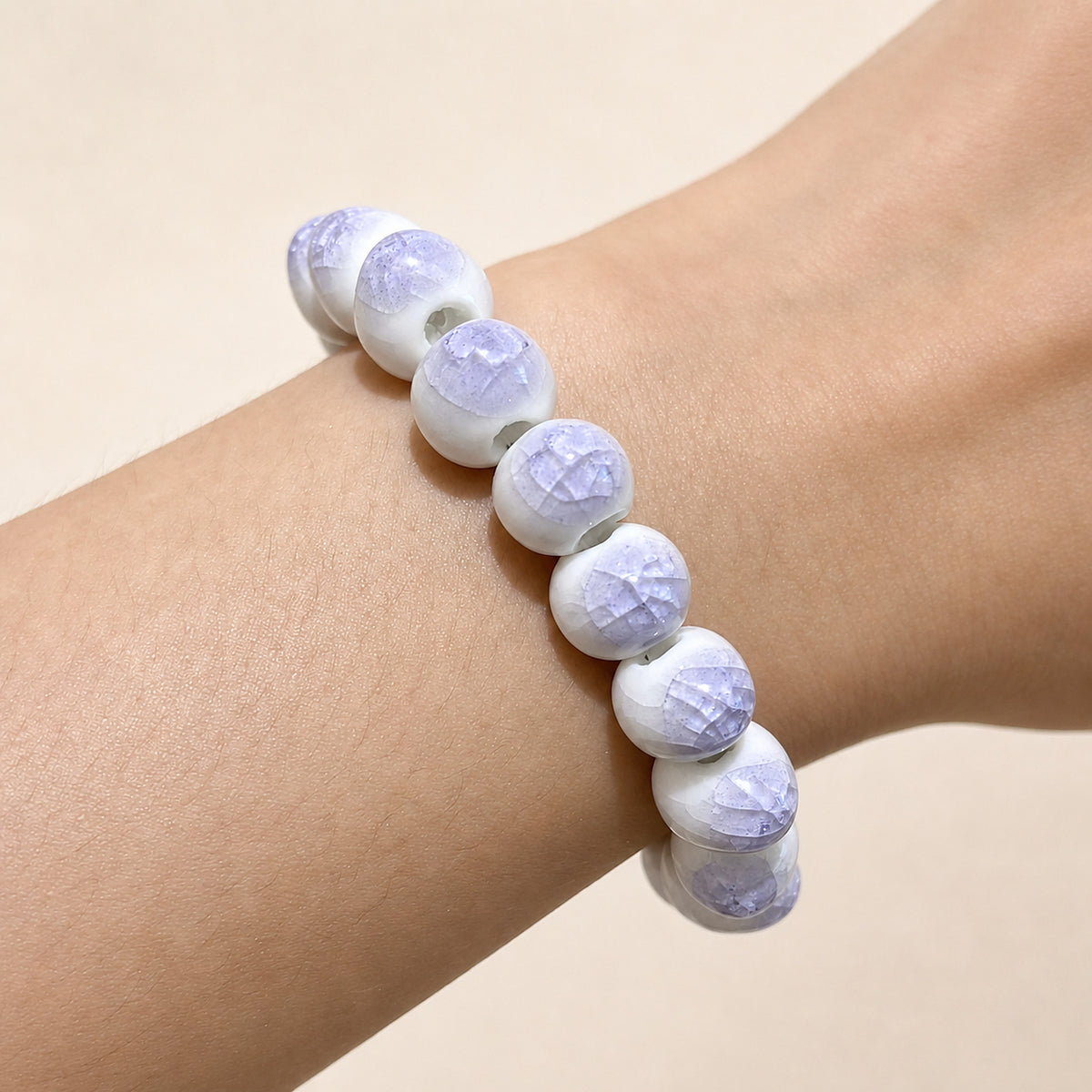 LUMI purple ice-crackle glaze ceramic bracelet 10mm worn on the wrist — handmade Jingdezhen porcelain, wrist shot 2