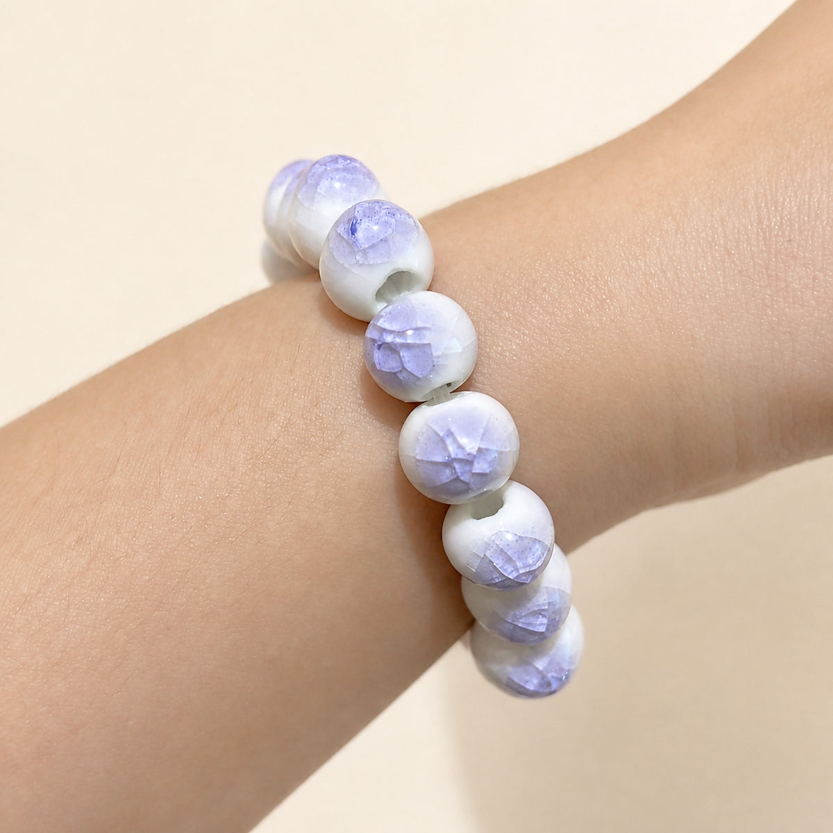 LUMI purple ice-crackle glaze ceramic bracelet 10mm worn on the wrist — handmade Jingdezhen porcelain, wrist shot 3