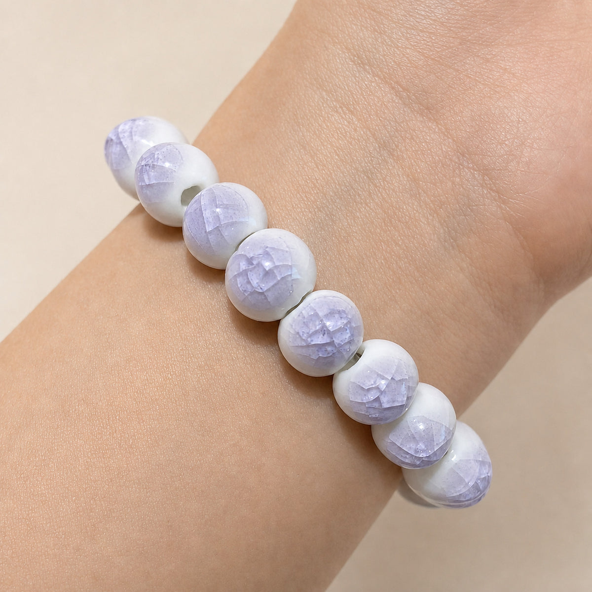 LUMI purple ice-crackle glaze ceramic bracelet 10mm worn on the wrist — handmade Jingdezhen porcelain, wrist shot 4