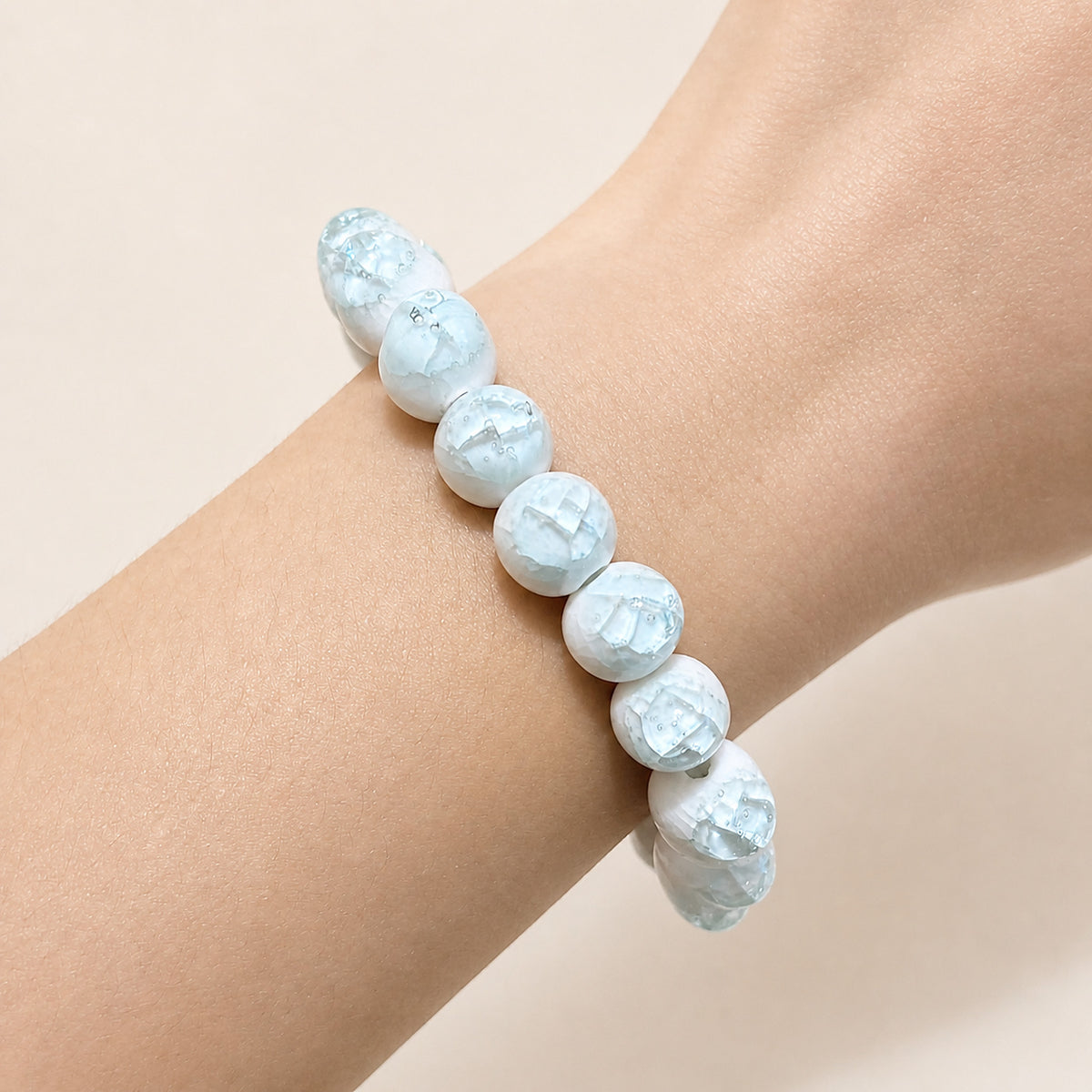 LUMI sky blue ice-crackle glaze ceramic bracelet 10mm worn on the wrist — handmade Jingdezhen porcelain, wrist shot 2
