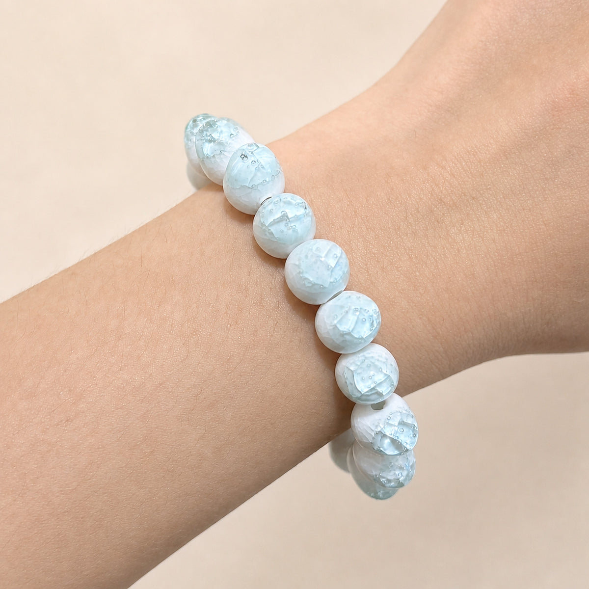 LUMI sky blue ice-crackle glaze ceramic bracelet 10mm worn on the wrist — handmade Jingdezhen porcelain, wrist shot 5