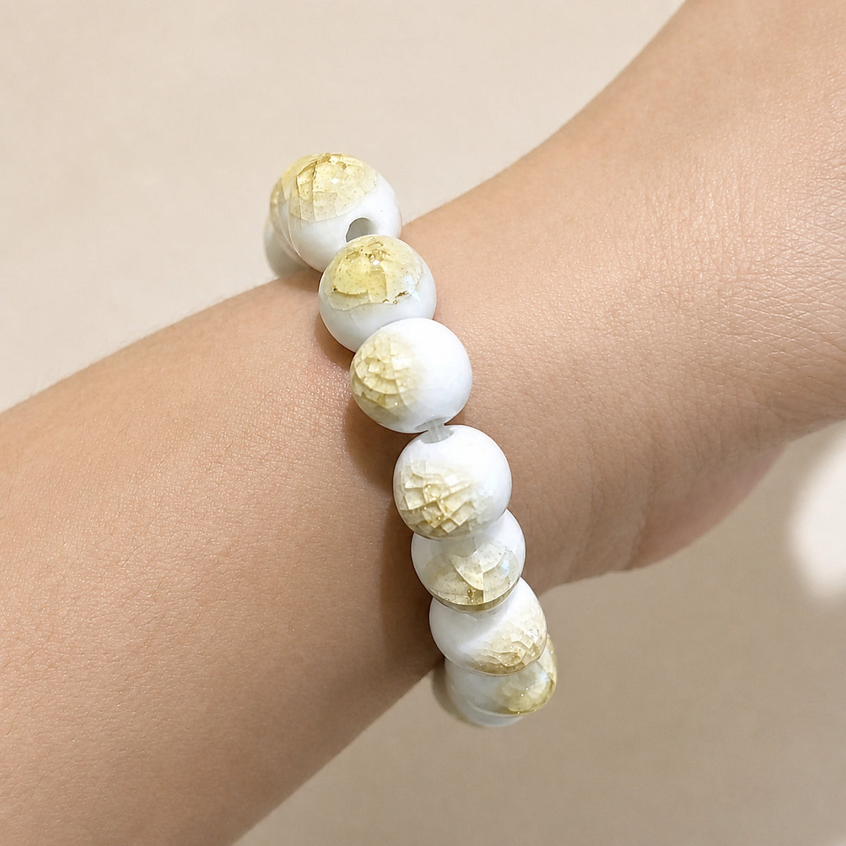 LUMI yellow ice-crackle glaze ceramic bracelet 10mm worn on the wrist — handmade Jingdezhen porcelain, wrist shot 2