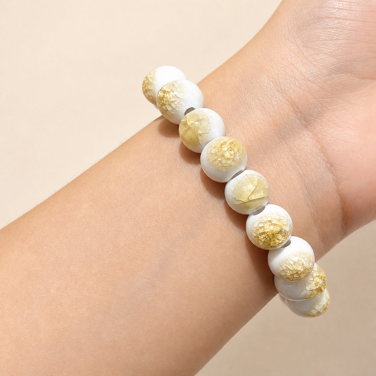 LUMI yellow ice-crackle glaze ceramic bracelet 10mm worn on the wrist — handmade Jingdezhen porcelain, wrist shot 3