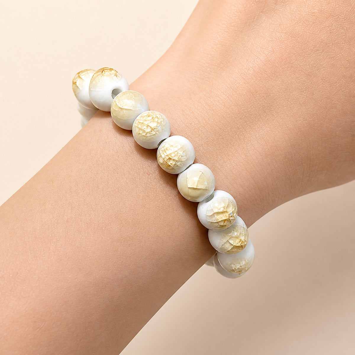 LUMI yellow ice-crackle glaze ceramic bracelet 10mm worn on the wrist — handmade Jingdezhen porcelain, wrist shot 4