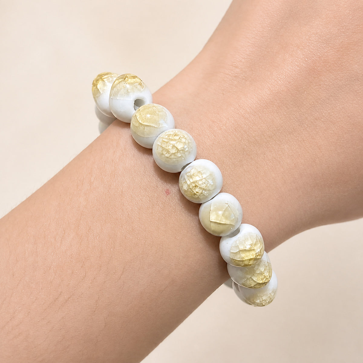 LUMI yellow ice-crackle glaze ceramic bracelet 10mm worn on the wrist — handmade Jingdezhen porcelain, wrist shot 5