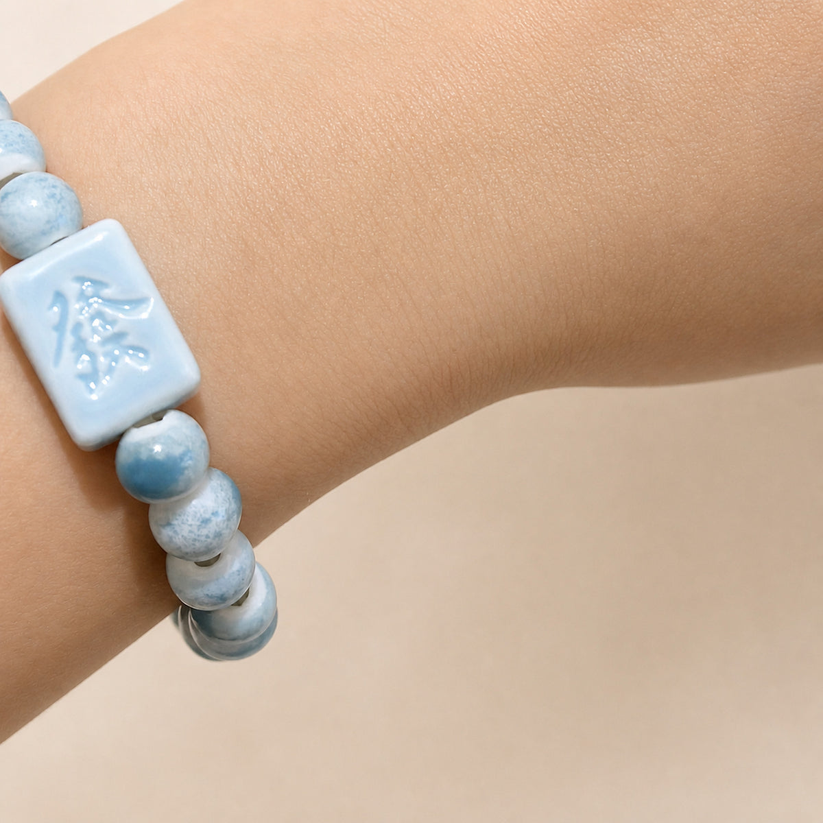 LUMI blue 發 fortune character ceramic bracelet 8mm — close-up of glaze texture and hand-finished beads
