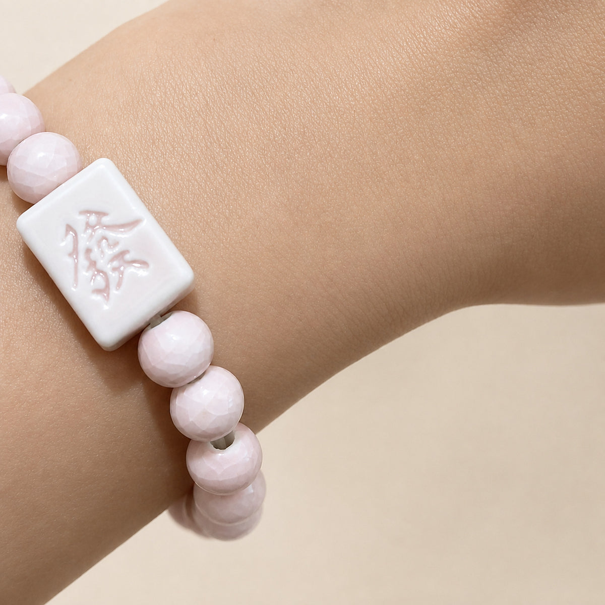 LUMI pink 發 fortune character ceramic bracelet 8mm — close-up of glaze texture and hand-finished beads