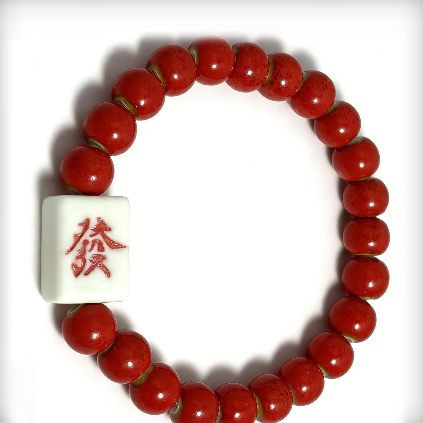 LUMI FA Character ceramic bracelet in deep red glaze with hand-painted 發 bead — front view