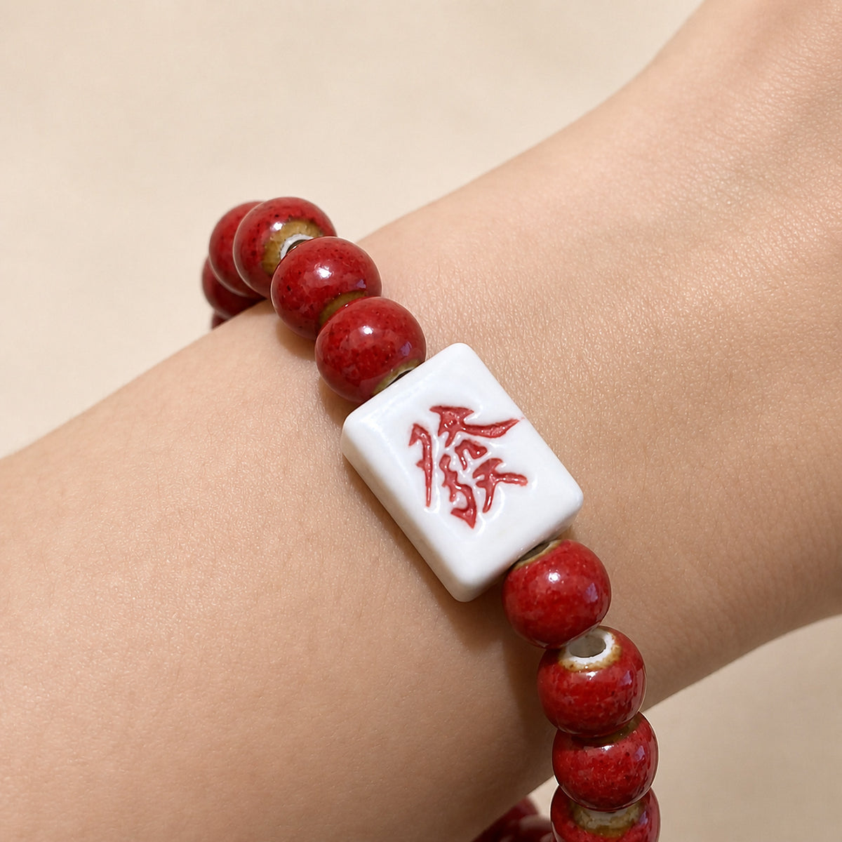 LUMI red 發 fortune character ceramic bracelet 8mm — close-up of glaze texture and hand-finished beads