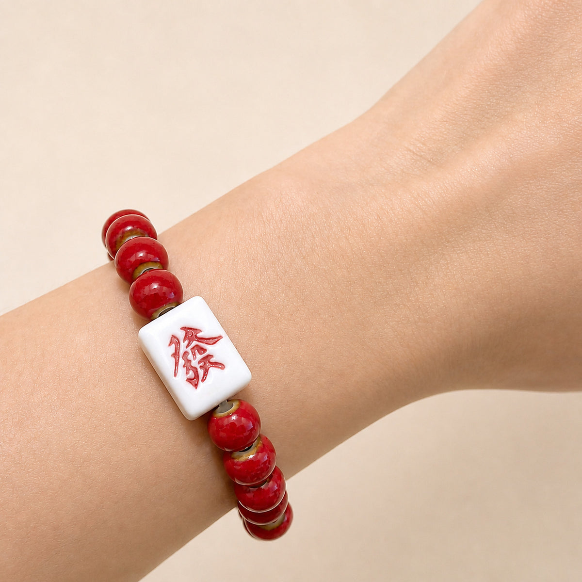 LUMI red 發 fortune character ceramic bracelet 8mm worn on the wrist — handmade Jingdezhen porcelain, wrist shot 4