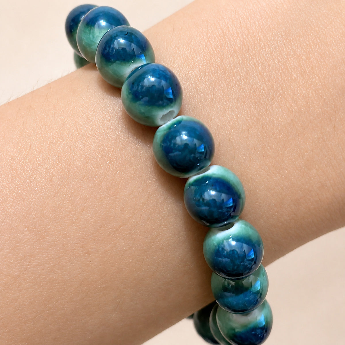 LUMI forest green ceramic bracelet 10mm — close-up of glaze texture and hand-finished beads