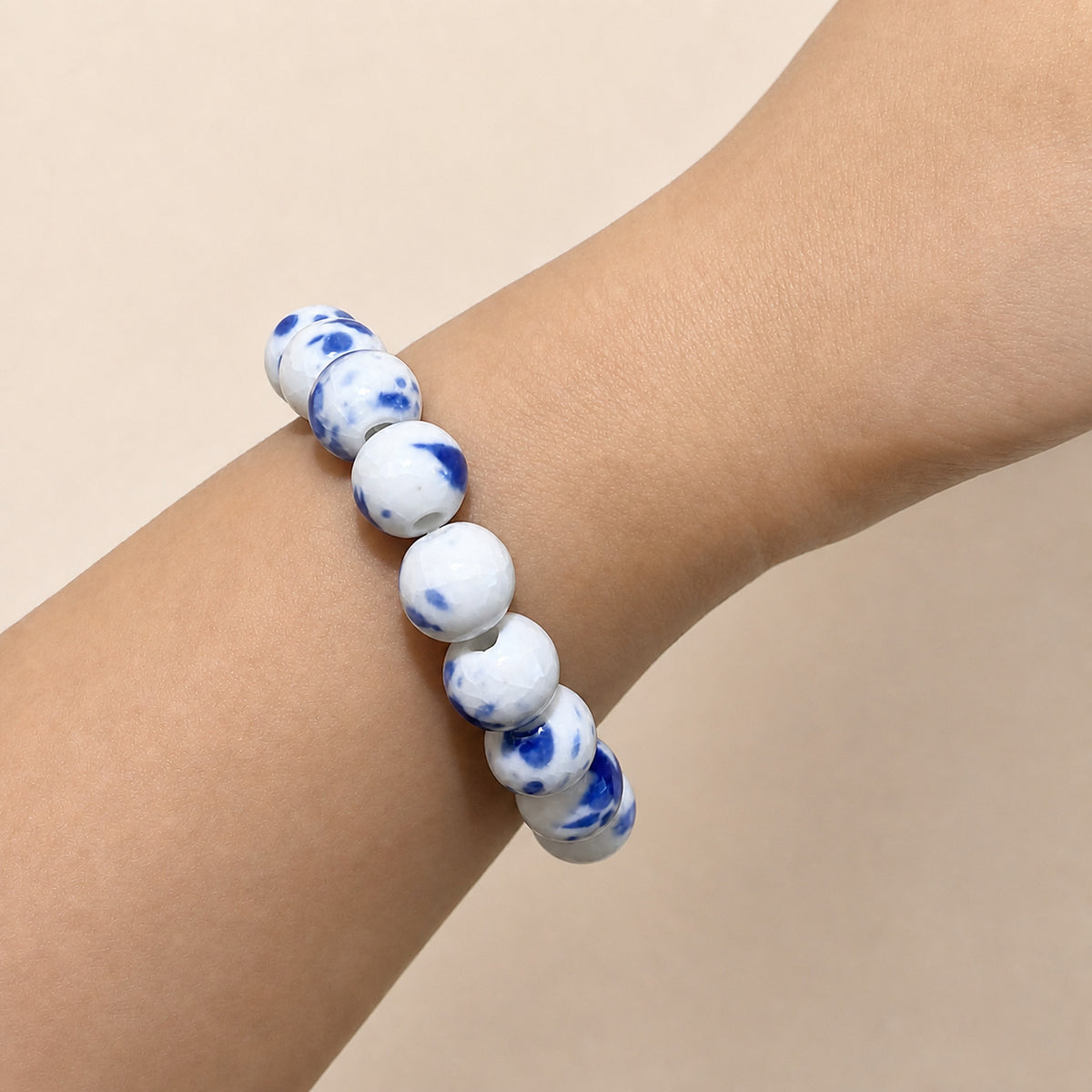 LUMI Qing Hua blue-and-white porcelain bracelet 10mm worn on the wrist — handmade Jingdezhen porcelain, wrist shot 3