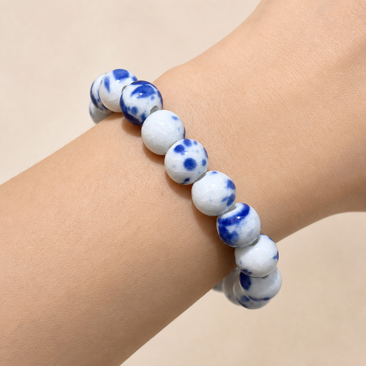 LUMI Qing Hua blue-and-white porcelain bracelet 10mm worn on the wrist — handmade Jingdezhen porcelain, wrist shot 5