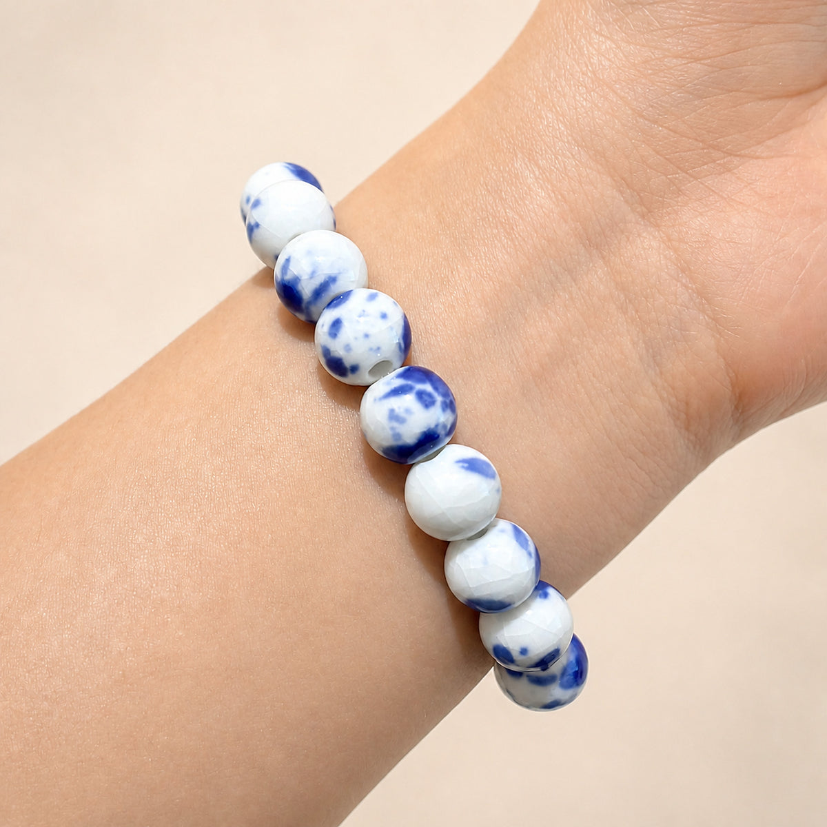 LUMI Qing Hua blue-and-white porcelain bracelet 10mm worn on the wrist — handmade Jingdezhen porcelain, wrist shot 6