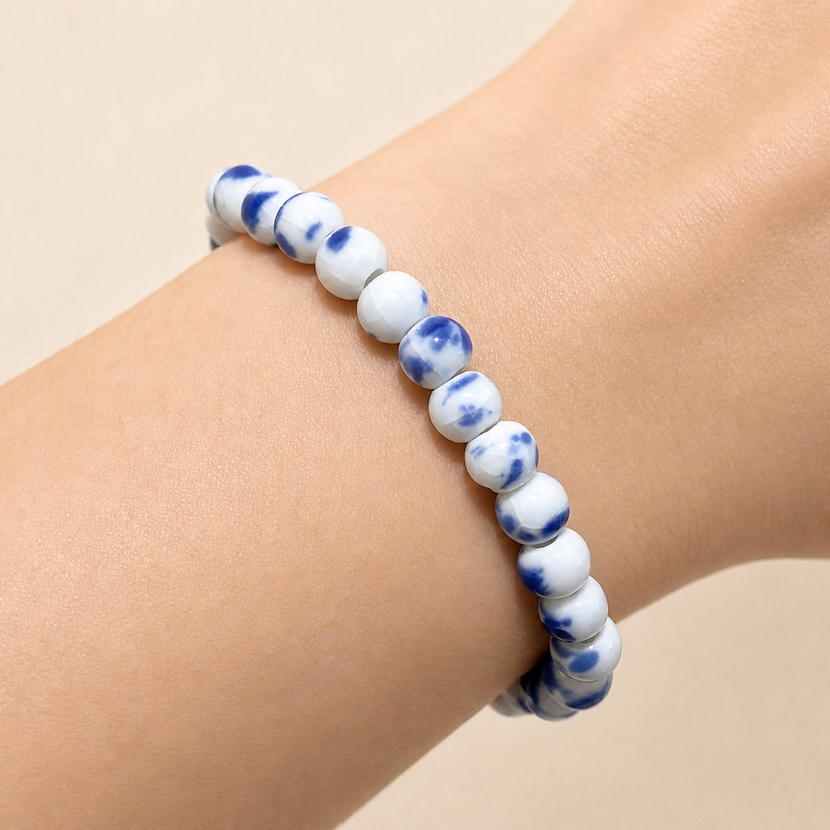 LUMI Qing Hua blue-and-white porcelain bracelet 6mm worn on the wrist — handmade Jingdezhen porcelain, wrist shot 3