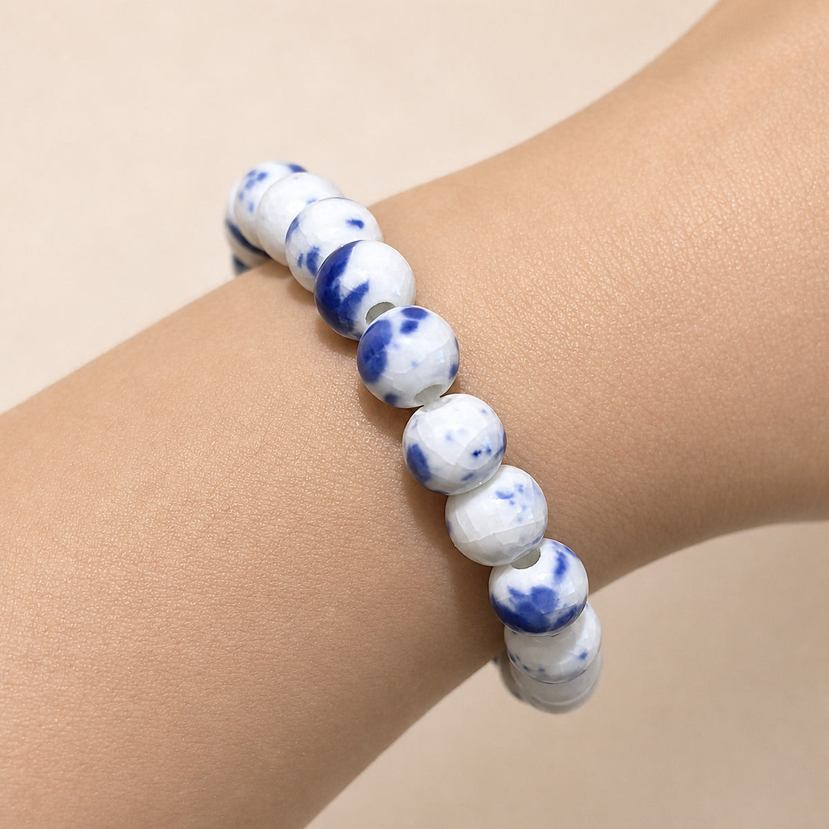 LUMI Qing Hua blue-and-white porcelain bracelet 8mm worn on the wrist — handmade Jingdezhen porcelain, wrist shot 3