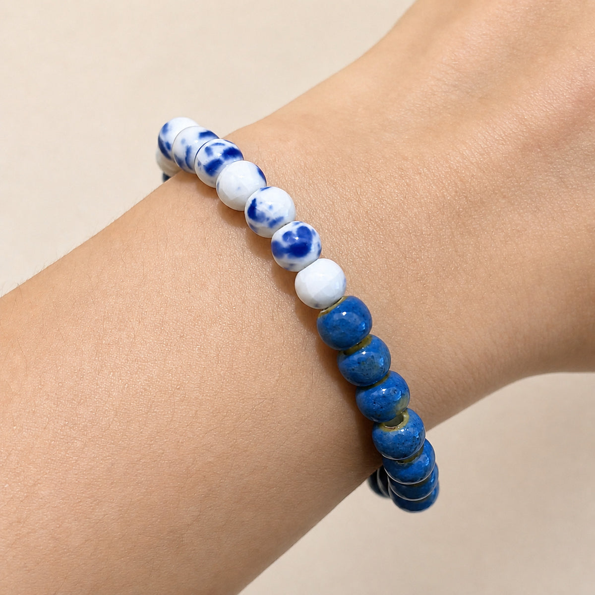 LUMI cobalt blue and Qing Hua mixed ceramic bracelet 6mm worn on the wrist — handmade Jingdezhen porcelain, wrist shot 1