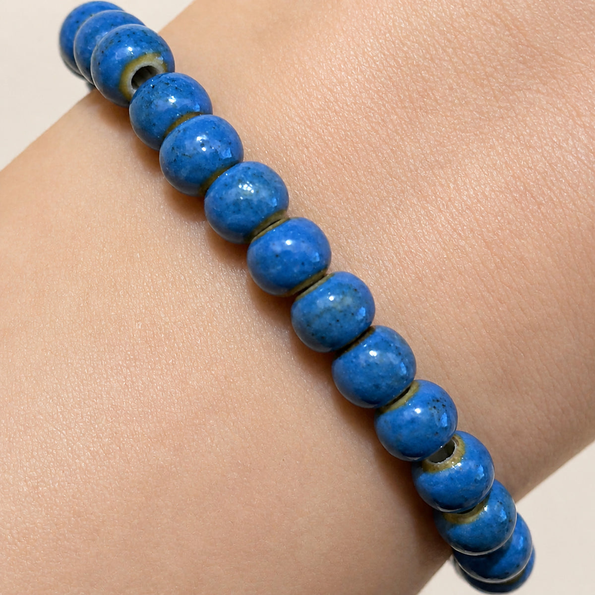 LUMI cobalt blue ceramic bracelet 6mm — close-up of the flecked cobalt glaze